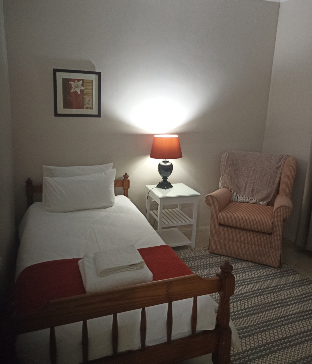Second bedroom with single bed and reading chair